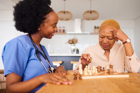 216993352-black-people-nurse-and-thinking-in-elderly-care-for-chess-fun-or-social-activity-together-at-home